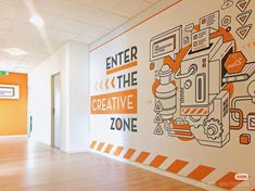 an office hallway painted with orange and white graphics