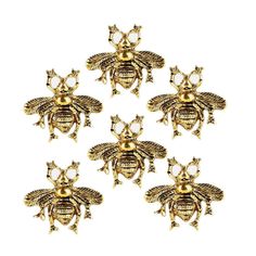 six gold bees sitting on top of each other