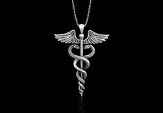 The Caduceus is an ancient Greek or Roman herald's wand, typically one with two serpents twined around it, carried by the messenger god Hermes or Mercury. a representation of this, traditionally associated with healing. Some accounts suggest that the oldest known imagery of the caduceus have their roots in a Mesopotamian origin with the Sumerian god Ningishzida whose symbol, a staff with two snakes intertwined around it, dates back to 4000 B.C. to 3000 B.C 1.Pendant info. Material: Sterling Silv Snakes Intertwined, Doctor Necklace, Presents For Nurses, Rod Of Asclepius, God Hermes, Snake Tail, Two Snakes, Gift For Doctor, Medical Jewelry