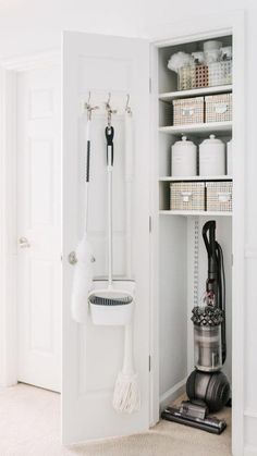 a white closet filled with lots of different types of cleaning supplies and accessories in it