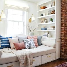 a living room filled with lots of white furniture