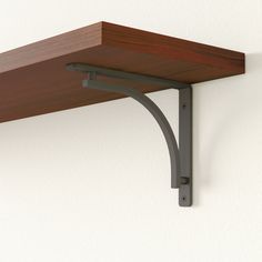 a wooden shelf with metal brackets on it