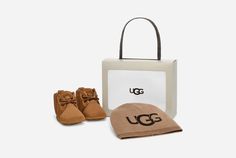 It's:  inchIsn't that the cutest thing you've ever seen?! inch in a gift bag. The Baby Neumel and UGG® Beanie gift set wraps up everything you need to show your love for those expectant parents who just invited you to their shower or for your own little one at home.This suede bootie and knit logo beanie make the perfect pair. Bonus kid tip: Match with mom or dad in the Neumel in adult sizing. | Baby Beanie. Blended Polyester and Nylon knit hat with printed UGG® logo. Baby Neumel Bootie. Suede up Ugg Neumel Boots, Ugg Store, Ugg Neumel, Baby Uggs, Knit Logo, Kid Clothes, Cycling Fashion, Baby Boots, Classic Boots