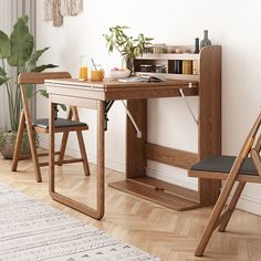 a wooden desk with two chairs next to it in front of a white wall and potted plant