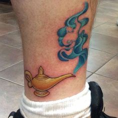 a person with a tattoo on their leg that has a hook in the middle of it