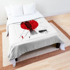 a bed with a red umbrella on it in a room next to a white wall