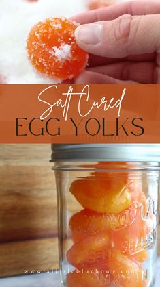 a hand holding an orange in a jar with the words salted egg yolks above it