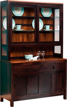 a wooden hutch with glass doors and plates on it