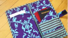 a purple and blue bag with a passport in it