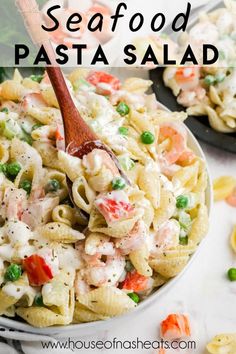 this seafood pasta salad is loaded with fresh peas, carrots, and chicken it's ready to be eaten