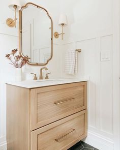 a bathroom with a sink, mirror and towel rack