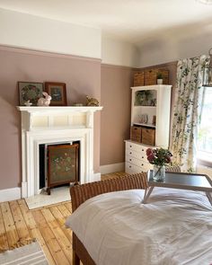 a bedroom with a bed and fireplace in it