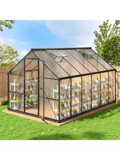 a small greenhouse with several plants growing in the ground and on top of it's roof