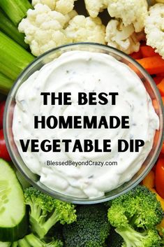 the best homemade vegetable dip is in a bowl surrounded by broccoli, carrots and cauliflower