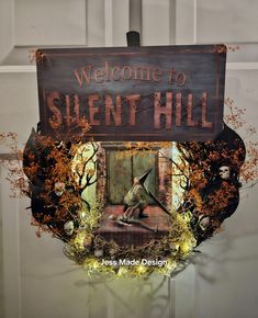 there is a sign that says welcome to silent hill with an image of a man on it