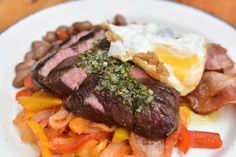 a white plate topped with meat and vegetables