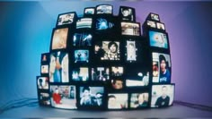 a large display of television's with multiple pictures on them in the shape of a ball