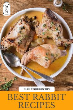 two pieces of chicken in a yellow sauce on a plate with spoons and herbs