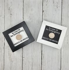 two wooden buttons in a black and white frame on a wood background with the words, in effect of an energy brick on wood