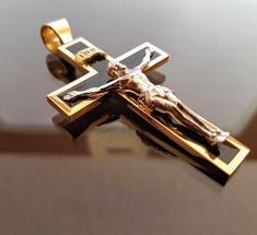 a gold cross with a crucifix on it