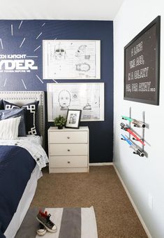 a bedroom decorated in blue and white with pictures on the wall, bedding and rugs