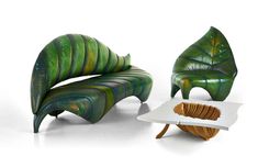 two green leaf shaped chairs sitting next to each other