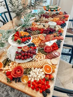 a table topped with lots of different types of fruit and cheese on top of it