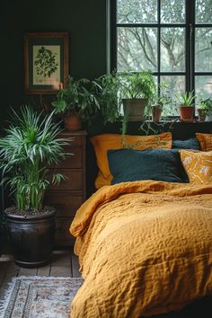 Lush indoor plants in rustic planters adding life to a dark boho bedroom. Dark Green Bedroom Aesthetic Ideas, Rug Earth Tones, Terra Cotta And Teal Bedroom, Earth Tone Apartment Aesthetic, Reclaimed Wood Furniture Bedroom, Teal And Terracotta Bedroom, Dark Green And Terracotta Bedroom, Earth Tone Bedroom Colors, Blue Earthy Bedroom