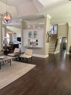 a living room filled with furniture and a staircase