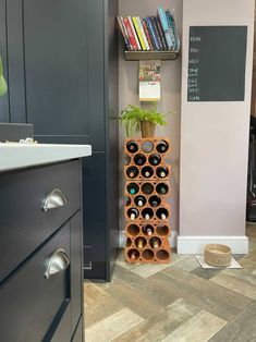 there is a wine rack with many bottles on it in the corner of this kitchen