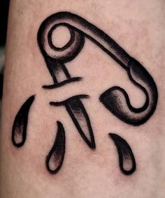 a black and white photo of a tattoo design on the leg with scissors in it