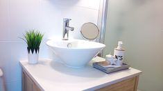 a white sink sitting on top of a bathroom counter