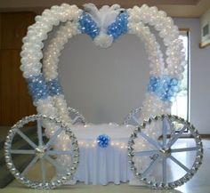 a white and blue carriage decorated with balloons