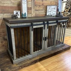 the dog kennel is made out of wood and metal bars, with an open door at the top