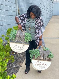 a woman holding two baskets with plants in them and the words welcome to me on it