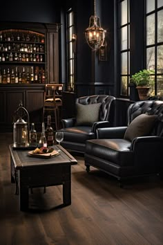 a living room filled with black furniture and lots of bottles on top of the table