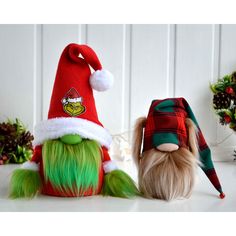 two stuffed animals wearing christmas hats next to each other