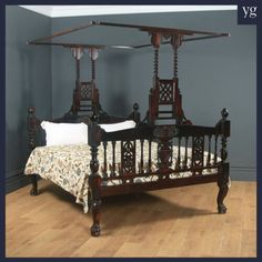 a wooden bed with four posts in a room next to a wall and hardwood flooring