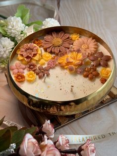 a cake decorated with flowers on top of a table