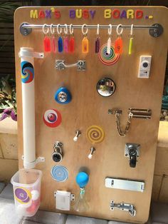 a wooden board with magnets, keys and other items attached to the back of it