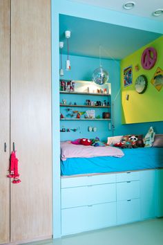 a bedroom with blue and green walls and shelves