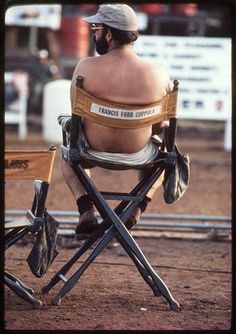 a man sitting in a chair with his back turned to the camera