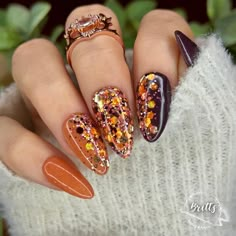 Gorgeous mani features Punkin Spice, Deep Plum, and Cozy, our gorgeous chunky glitter mix with shades of pumpkin, brown, golds and pink.  These colors are perfect to transition into your fall manis.   Dip powders are .25oz jars.  5-7 manis  The number of manis will depend on how many layers of dip you like.  We like 2 layers of dip for solids and most glitters.  Some glitters look great with just one dip.  All of our swatches have been dipped twice.   We add a layer of our Krystal clear dip on top of all glitters and foils. We suggest pouring dip into a cupcake liner, giving it a good mix and then giving it a little shake to bring any glitter or sparkles to the top.  For glitter dips, we like to turn our hand over and "lay" the finger down into the dip and then give everything a very light Glitter Nails Fall Colors, Fall Gold Flake Nails, 2 Color Nail Polish Ideas, Yellow Jacket Nails, Fall Nails Each Nail Different Color, Thanksgiven Nails, Fall Nail Square, Olive Green Glitter Nails, Olive Green Cheetah Nails