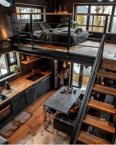 an aerial view of a loft with stairs leading up to the bedroom