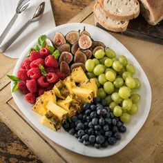 a white plate topped with fruit and bread