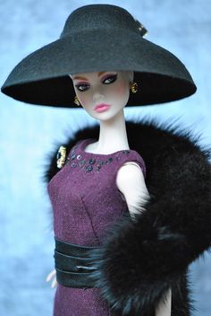 a barbie doll wearing a black hat and purple dress with fur stole around her neck