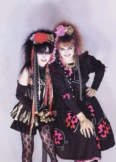 two women dressed in costume posing for a photo