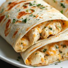 two chicken burritos on a white plate