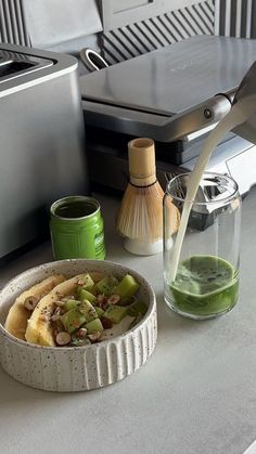 there is a bowl of fruit and juice on the counter