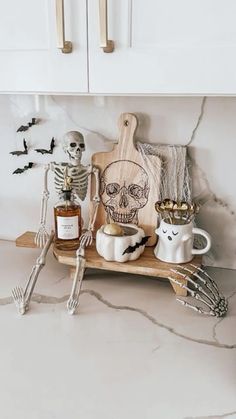 halloween decorations on a kitchen counter with skeleton figurines